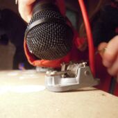 Close-up of a microphone held up to a small music box