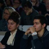 Two people from the audience listen to a lecture