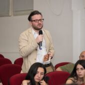 Zaal Andronikashvili stands and asks a question into a microphone
