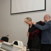 Giga Zedania helps Sigrid Weigel put on her honorary robe