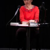 Ulrike Draesner sits behind a microphone