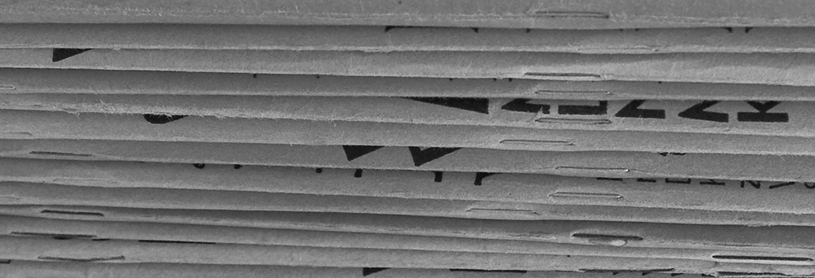 Detail of black and white photo of stacked magazines.